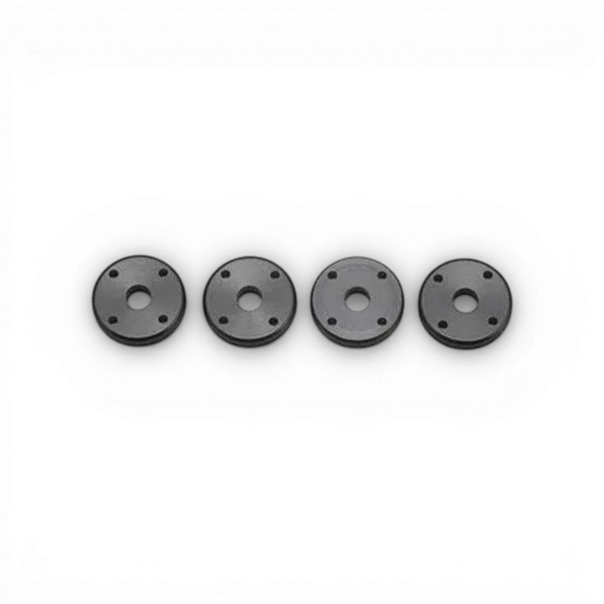 Pistons 4 trous de 1,1mm pour amortisseur Big Bore, pièces détachées de marque Team Yokomo, visibles en détail.
