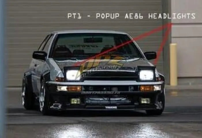 Kit d'éclairage rétractable pour Toyota AE86, personnalisé par D-magic JP, avec câbles et composants visibles en action.