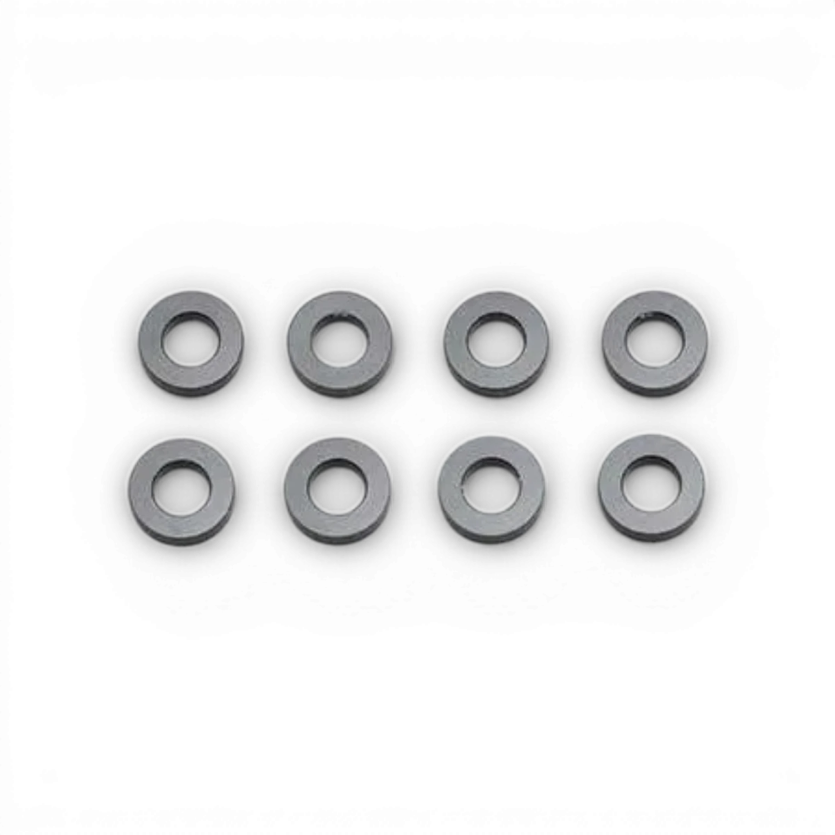 Rondelles noires 3x6x1,5mm de pièces détachées Team Yokomo, vues en gros plan sur fond blanc.