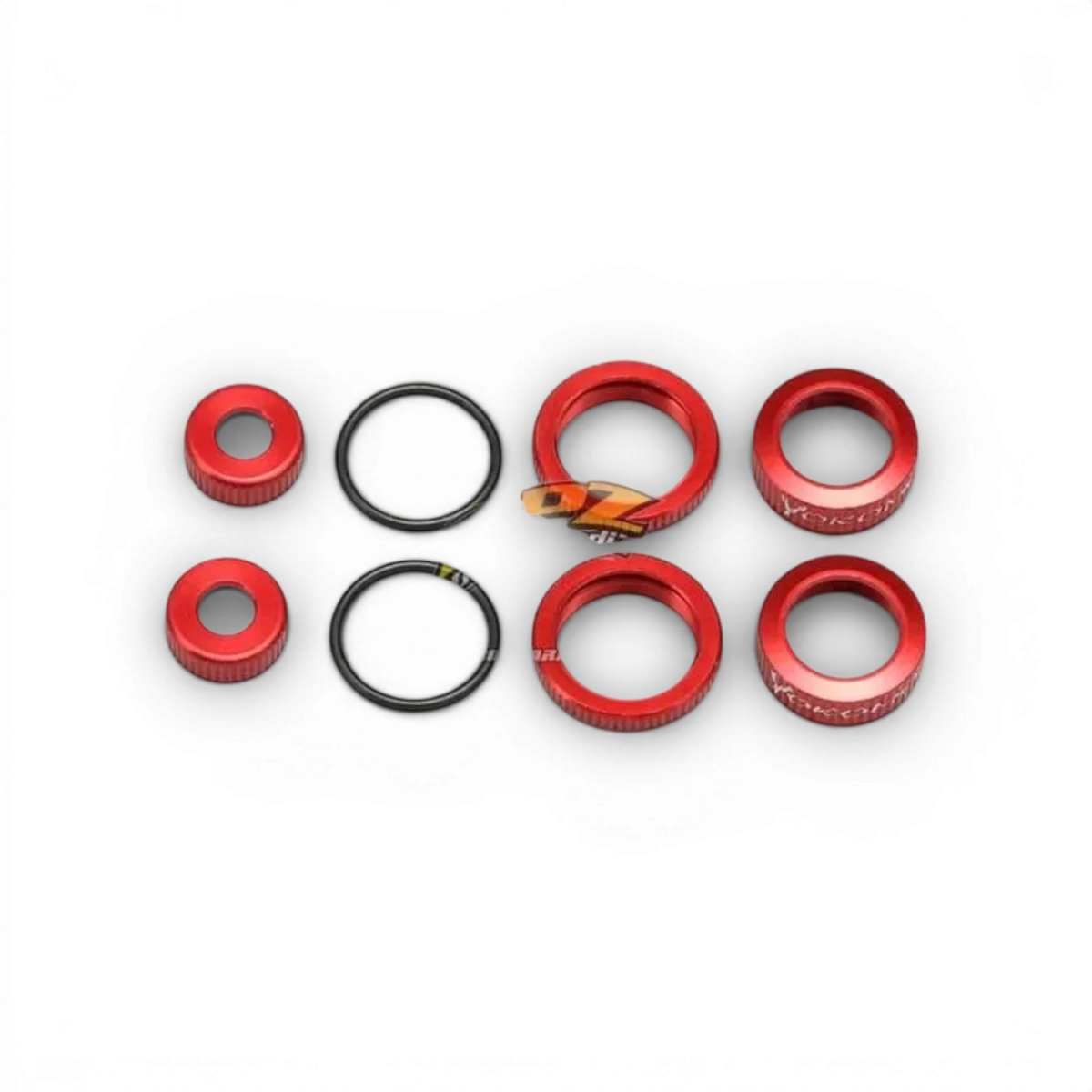 Kit de bouchons Bigbore rouges pour pièces détachées Team Yokomo, visible avec bouchons en caoutchouc rouge.